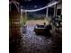 Backyard at night with string lights and a brick fire pit at 16325 Magnolia Bluff Dr, Montverde, FL 34756