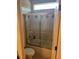 Bathroom featuring a toilet and a tiled, glass-enclosed shower over the tub at 16325 Magnolia Bluff Dr, Montverde, FL 34756