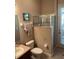 Bathroom featuring a vanity with sink, toilet and a modern, glass-enclosed shower at 16325 Magnolia Bluff Dr, Montverde, FL 34756
