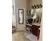 Bathroom featuring a vanity with sink, toilet and a tiled, glass-enclosed shower over the tub at 16325 Magnolia Bluff Dr, Montverde, FL 34756