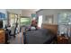 Cozy bedroom with a large window overlooking beautiful views, desk, and a comfortable bed at 16325 Magnolia Bluff Dr, Montverde, FL 34756
