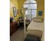 Bright bedroom features a four-poster bed, desk, and large window offering natural light at 16325 Magnolia Bluff Dr, Montverde, FL 34756