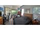 Comfortable bedroom featuring a large bed, bright windows offering lovely views, and neutral wall color at 16325 Magnolia Bluff Dr, Montverde, FL 34756