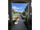 View from the front entrance showing a neatly landscaped walkway leading to a well-maintained street at 16325 Magnolia Bluff Dr, Montverde, FL 34756