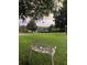 Relaxing front yard view with a classic white bench and lush greenery at 16325 Magnolia Bluff Dr, Montverde, FL 34756