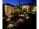 Beautifully lit front yard landscaping leading to a well-maintained home at twilight at 16325 Magnolia Bluff Dr, Montverde, FL 34756