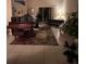 View of a spacious living room with tile flooring, grand piano, and sliding glass doors to the outdoor patio at 16325 Magnolia Bluff Dr, Montverde, FL 34756