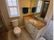 Bathroom with granite countertop vanity, framed mirror and window for natural lighting at 2414 Willow Oak Dr, Edgewater, FL 32141