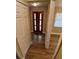 Well-lit hallway featuring wood floors and a decorative front door at 2414 Willow Oak Dr, Edgewater, FL 32141