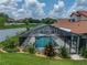 Aerial view showcasing the screened-in pool and patio with manicured landscaping, creating a private oasis at 3939 Sunset Lake Dr, Lakeland, FL 33810