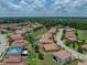 A beautiful property is displayed from an aerial view, situated in a well-maintained community with green spaces and clear skies at 3939 Sunset Lake Dr, Lakeland, FL 33810