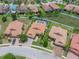 An aerial view of a lovely home featuring a screened pool enclosure, complemented by lush landscaping at 3939 Sunset Lake Dr, Lakeland, FL 33810