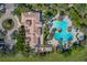 Aerial view showcases a beautifully landscaped community pool, clubhouse with ample seating and shade at 3939 Sunset Lake Dr, Lakeland, FL 33810