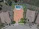 Stunning aerial view of property featuring a pool and spa, surrounded by lush landscaping and an attractive roofline at 3939 Sunset Lake Dr, Lakeland, FL 33810