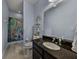 Cozy bathroom featuring blue walls, granite counters, toilet, sink, decorative shelving, and mermaid themed shower curtain at 3939 Sunset Lake Dr, Lakeland, FL 33810