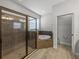 Bathroom showcasing a glass enclosed shower and a separate tub in a well-lit space at 3939 Sunset Lake Dr, Lakeland, FL 33810