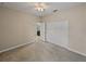 Bright bedroom with neutral walls, plush carpeting, ceiling fan, and access to a closet and en-suite at 3939 Sunset Lake Dr, Lakeland, FL 33810