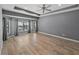 Spacious primary bedroom featuring tray ceilings, tile floors, and a window overlooking the pool at 3939 Sunset Lake Dr, Lakeland, FL 33810
