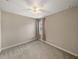 Bedroom featuring neutral walls, carpeted flooring, a ceiling fan, and a window with curtains at 3939 Sunset Lake Dr, Lakeland, FL 33810