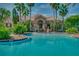 An inviting community pool with tropical landscaping complements a stylish building with archways, stone and tile details at 3939 Sunset Lake Dr, Lakeland, FL 33810