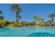A picturesque community pool provides a serene setting, complemented by the tall palm trees surrounding the pool and patio at 3939 Sunset Lake Dr, Lakeland, FL 33810