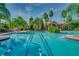 Community pool and beautiful building are showcased; the water invites relaxation, and palm trees add to the resort atmosphere at 3939 Sunset Lake Dr, Lakeland, FL 33810