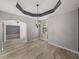 Dining room with unique tray ceilings, chandelier, tiled floors and natural lighting at 3939 Sunset Lake Dr, Lakeland, FL 33810