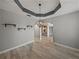 Dining room with unique tray ceilings, chandelier, tiled floors and natural lighting at 3939 Sunset Lake Dr, Lakeland, FL 33810