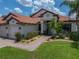 Inviting front entrance showcasing a well-manicured lawn and brick pathway to a charming home at 3939 Sunset Lake Dr, Lakeland, FL 33810
