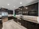Modern kitchen with stainless steel appliances, granite countertops, and dark cabinetry at 3939 Sunset Lake Dr, Lakeland, FL 33810