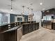 Large kitchen island with granite countertops and cabinets overlooking living area at 3939 Sunset Lake Dr, Lakeland, FL 33810