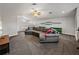 Bright living area with a large sectional couch, shelving, and a cozy atmosphere for relaxing and entertaining guests at 3939 Sunset Lake Dr, Lakeland, FL 33810