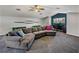 Inviting living space with a large gray sectional, a workspace, and modern decor creating a comfortable and functional area at 3939 Sunset Lake Dr, Lakeland, FL 33810