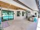 Inviting patio with a wood plank ceiling, a built-in kitchen, travertine tile and seamless access to the screened-in pool area at 3939 Sunset Lake Dr, Lakeland, FL 33810