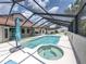 Screened-in pool area featuring a luxurious spa, perfect for relaxation and rejuvenation outdoors at 3939 Sunset Lake Dr, Lakeland, FL 33810