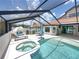 Enjoy the screened-in pool, spa, lounge seating, and dining, perfect for entertaining and relaxation at 3939 Sunset Lake Dr, Lakeland, FL 33810