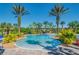 Resort-style community pool with palm trees and inviting lounge areas on a sunny day at 3939 Sunset Lake Dr, Lakeland, FL 33810