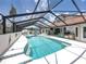 A serene screened-in pool area with outdoor seating, a built-in bar, and stylish decor for outdoor gatherings at 3939 Sunset Lake Dr, Lakeland, FL 33810