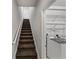 Carpeted stairs leading to a laundry room with white washer and dryer units and wire rack storage at 3939 Sunset Lake Dr, Lakeland, FL 33810