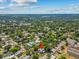 Aerial shot highlighting property location with a red pin, surrounded by mature trees and neighborhood charm at 485 E Stanford St, Bartow, FL 33830