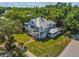 A two-story home with mature trees and a well-manicured lawn provides a serene and picturesque setting at 485 E Stanford St, Bartow, FL 33830