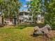 Expansive backyard with mature trees and a detached brick structure, offering ample outdoor space at 485 E Stanford St, Bartow, FL 33830