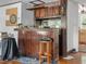 Close up of the home's original wet bar that features wooden bar, cabinets, and mirror at 485 E Stanford St, Bartow, FL 33830