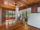 Sunroom with wood paneling, a ceiling fan, and several large windows at 485 E Stanford St, Bartow, FL 33830