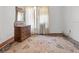 View of a bedroom with original hard wood floors and a vintage dresser with a mirror at 485 E Stanford St, Bartow, FL 33830