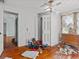 Bedroom with hardwood floors, white walls and ceiling, vintage dresser, and ceiling fan at 485 E Stanford St, Bartow, FL 33830