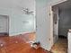 View of a bedroom leading to an attached bathroom and original hard wood floors at 485 E Stanford St, Bartow, FL 33830