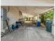 Open carport adjacent to the house featuring a concrete floor, ceiling fan, and an abundance of natural light at 485 E Stanford St, Bartow, FL 33830