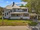 Charming multi-story home featuring a metal roof, inviting front porch, and convenient covered parking area at 485 E Stanford St, Bartow, FL 33830
