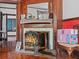 Ornate fireplace detailed with mantel, decorative fruit screen and vintage tile at 485 E Stanford St, Bartow, FL 33830
